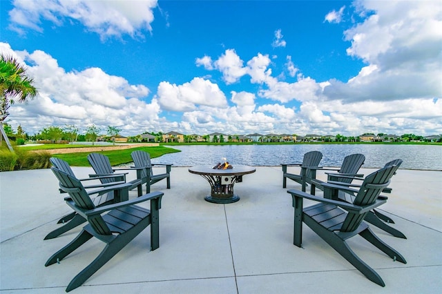 view of patio with a water view and an outdoor fire pit