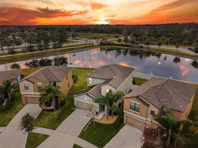 aerial view at dusk with a water view