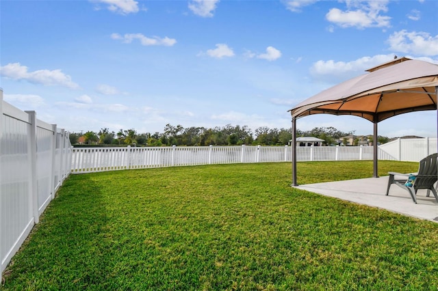 view of yard featuring a fenced backyard, a patio, and a gazebo