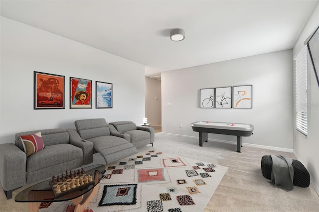 living room with light carpet and baseboards