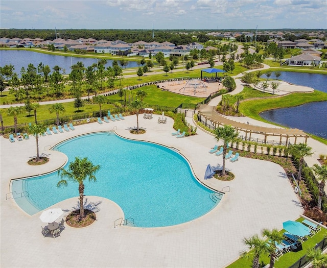 community pool featuring a water view and a residential view