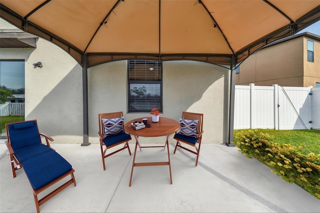 view of patio / terrace with a gazebo, fence, and a gate