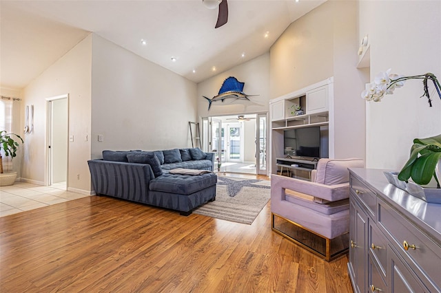 living room with high vaulted ceiling, light hardwood / wood-style floors, and ceiling fan