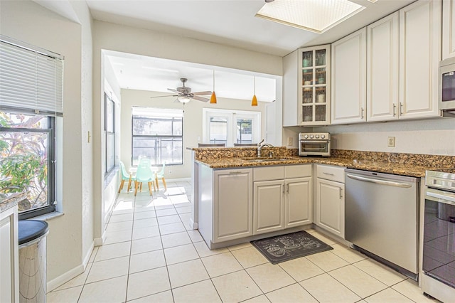 kitchen featuring white cabinetry, appliances with stainless steel finishes, kitchen peninsula, and sink