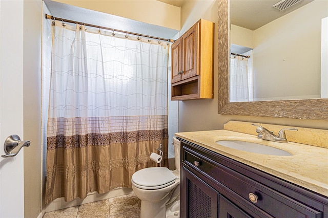 bathroom featuring tile patterned floors, vanity, and toilet