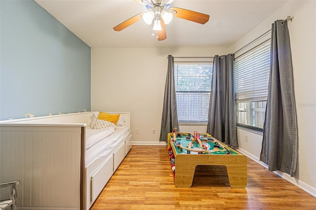 bedroom with ceiling fan and light hardwood / wood-style floors