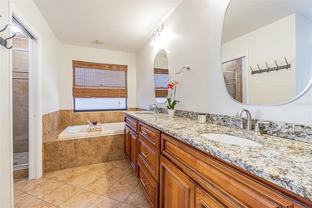 bathroom with vanity, independent shower and bath, tile patterned flooring, and a wealth of natural light