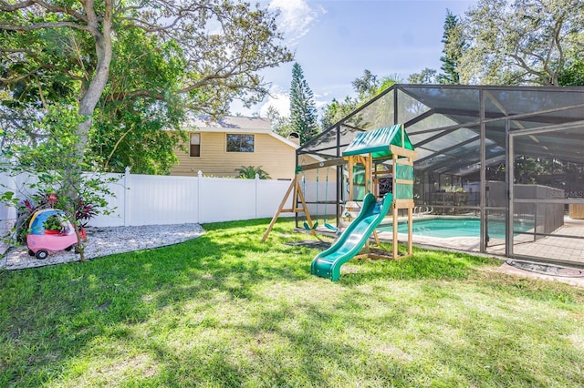 view of play area with a fenced in pool, a lawn, and glass enclosure