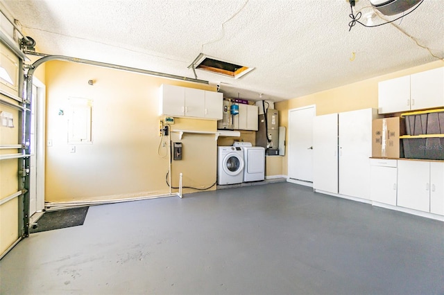 garage with water heater, electric panel, and washer and dryer