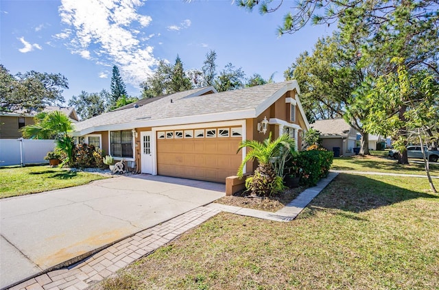 view of front of house with a garage and a front yard