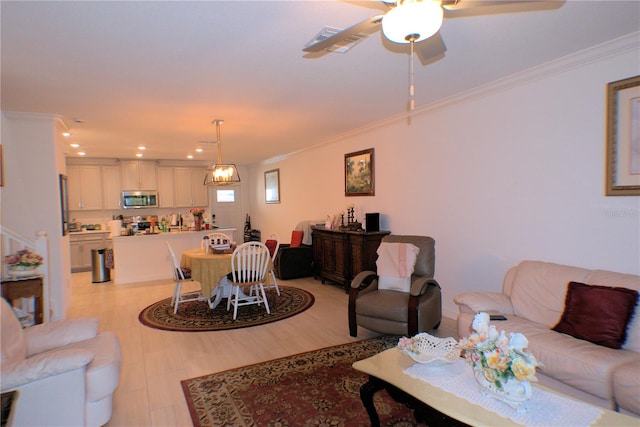 living room with crown molding, ceiling fan, and light hardwood / wood-style floors