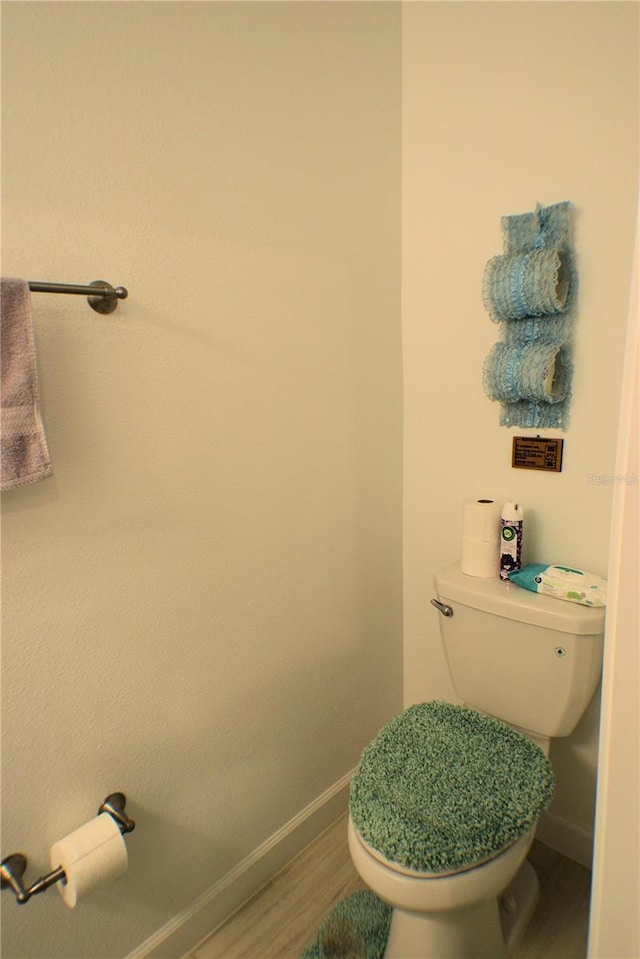 bathroom with hardwood / wood-style floors and toilet