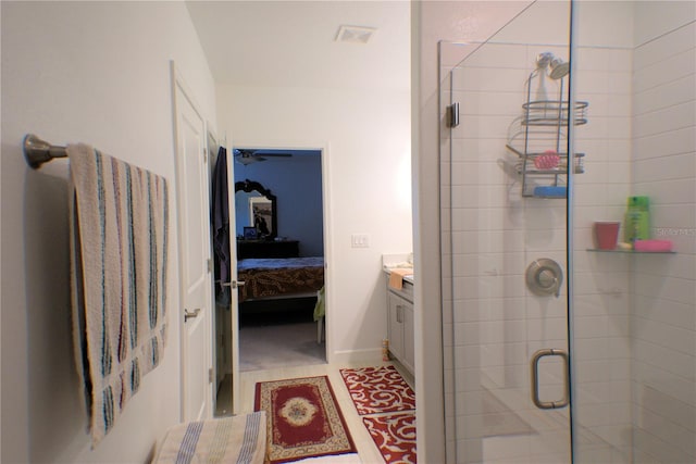 bathroom featuring walk in shower and vanity