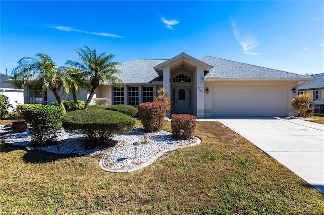 ranch-style home with a garage and a front yard