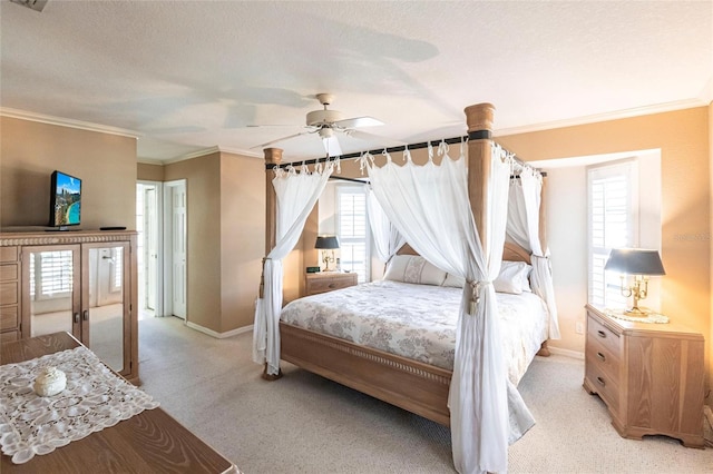 carpeted bedroom featuring ceiling fan, ornamental molding, and a textured ceiling