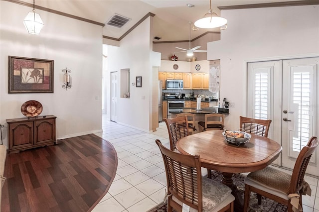 dining area featuring high vaulted ceiling, ornamental molding, light tile patterned floors, ceiling fan, and french doors