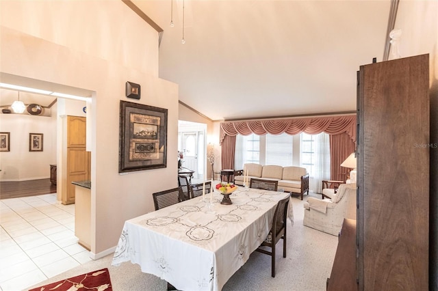 dining room with light tile patterned flooring and a towering ceiling