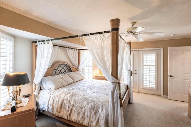 bedroom featuring ornamental molding, light carpet, access to exterior, and a textured ceiling