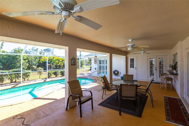 view of pool featuring a lanai, a patio, ceiling fan, and french doors