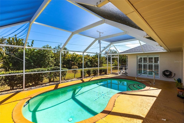 view of swimming pool featuring glass enclosure and a patio area