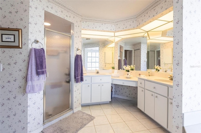 bathroom featuring a shower with door, vanity, and tile patterned flooring