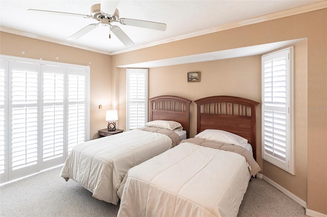 bedroom featuring crown molding, carpet floors, and ceiling fan