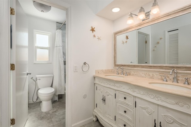 bathroom with vanity, curtained shower, and toilet