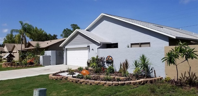 view of front of property with a garage and a front lawn