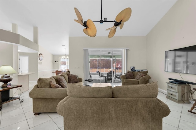 tiled living room with ceiling fan with notable chandelier