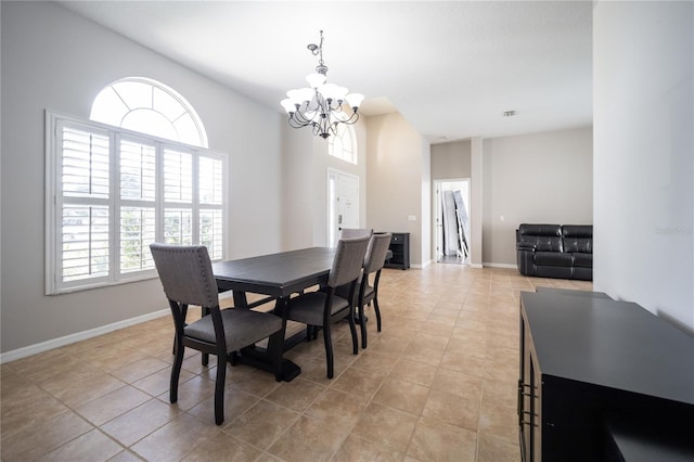 dining area with light tile patterned floors and a chandelier