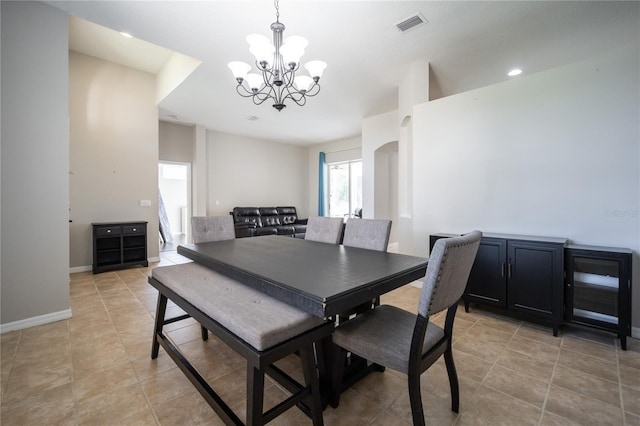 dining area featuring light tile patterned floors and a chandelier