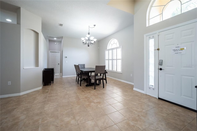 foyer featuring light tile patterned floors and a notable chandelier