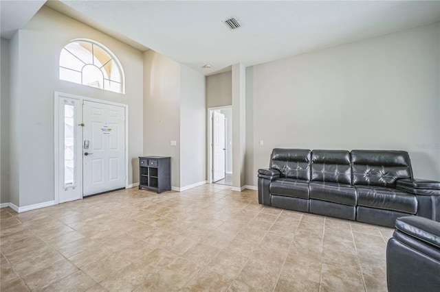 tiled foyer entrance featuring a high ceiling