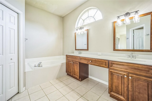 bathroom with vanity, tile patterned flooring, and a relaxing tiled tub