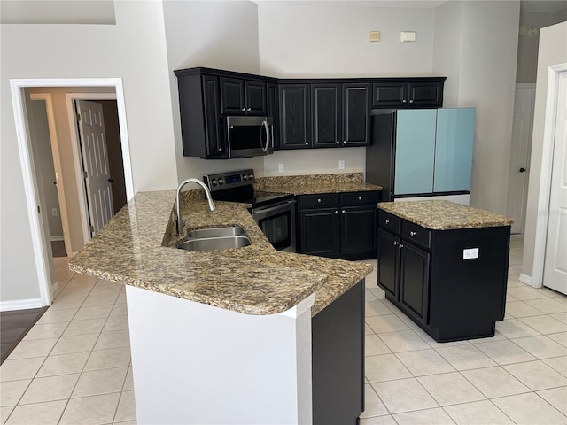 kitchen with sink, light tile patterned floors, stainless steel appliances, light stone countertops, and kitchen peninsula