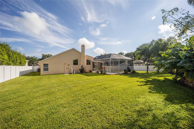 view of yard featuring a lanai and a swimming pool