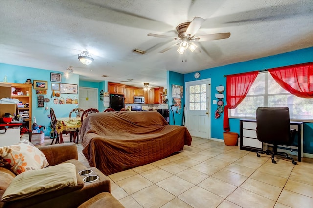 tiled living room with ceiling fan and a textured ceiling