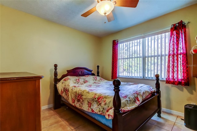 tiled bedroom with ceiling fan