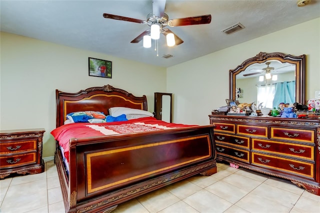 tiled bedroom featuring ceiling fan