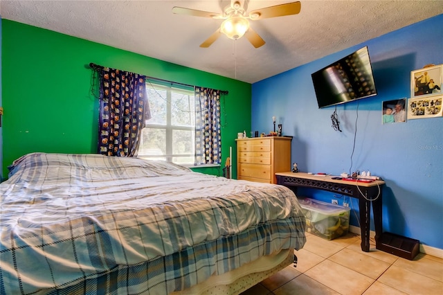 bedroom with a textured ceiling, tile patterned floors, and ceiling fan