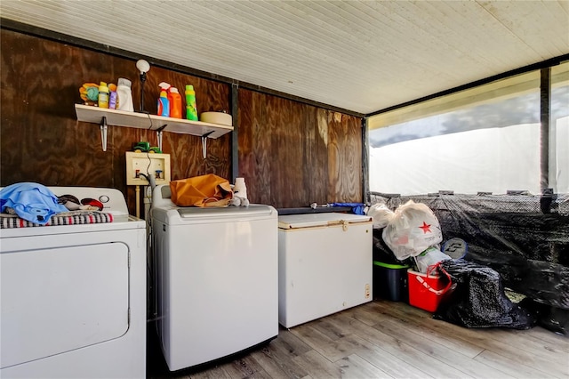 laundry room with separate washer and dryer and light wood-type flooring