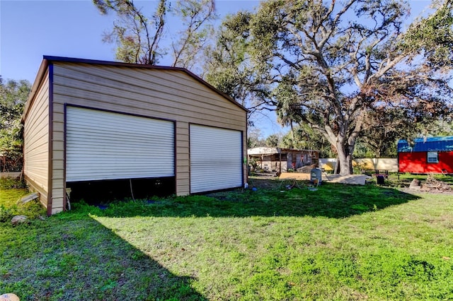 garage featuring a lawn