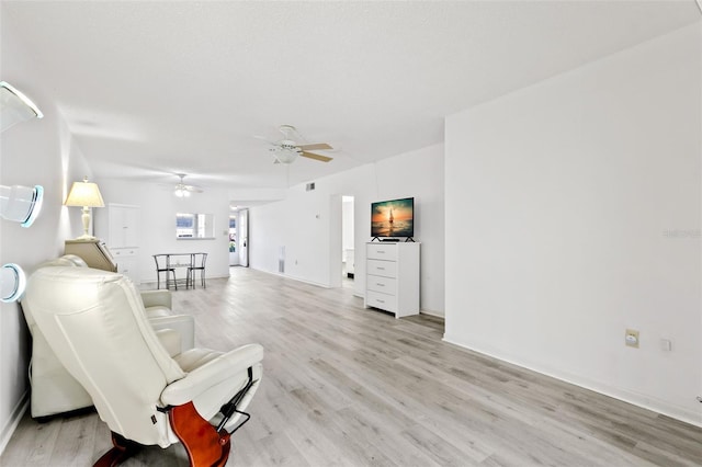 unfurnished living room with ceiling fan and light hardwood / wood-style flooring