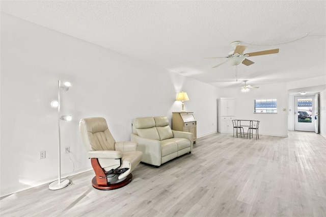 unfurnished room featuring ceiling fan, a textured ceiling, and light wood-type flooring