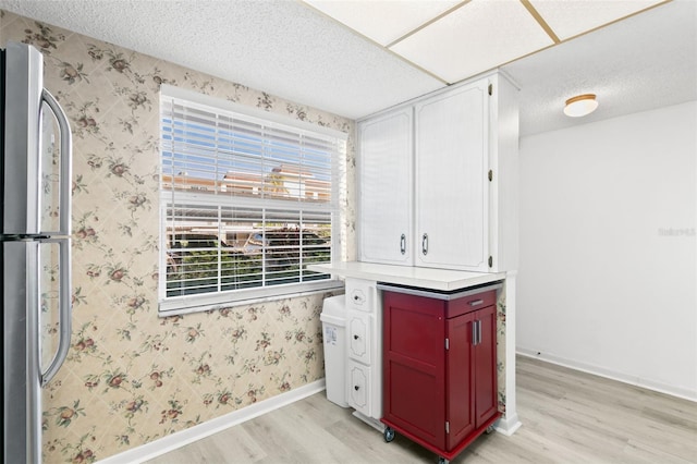 kitchen featuring light hardwood / wood-style flooring and stainless steel fridge