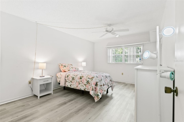 bedroom with ceiling fan and light wood-type flooring