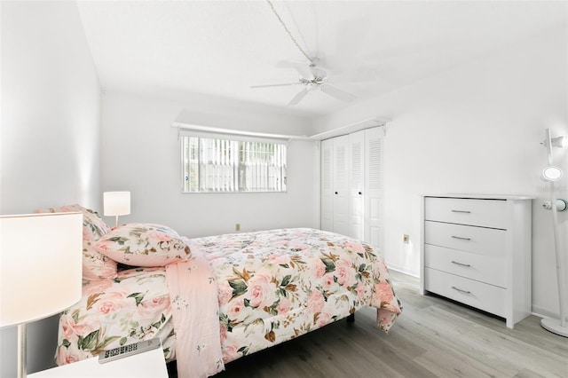 bedroom with light hardwood / wood-style flooring, a closet, and ceiling fan