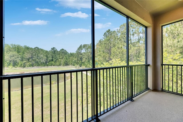 4899 Isola Ct, Wesley Chapel, FL 33543 - unfurnished sunroom featuring a view of trees