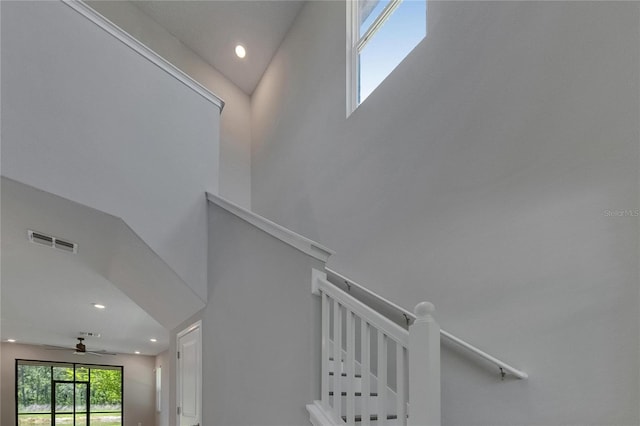 4899 Isola Ct, Wesley Chapel, FL 33543 - stairs with recessed lighting, a ceiling fan, and a towering ceiling