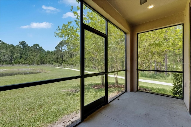 4899 Isola Ct, Wesley Chapel, FL 33543 - unfurnished sunroom with a view of trees